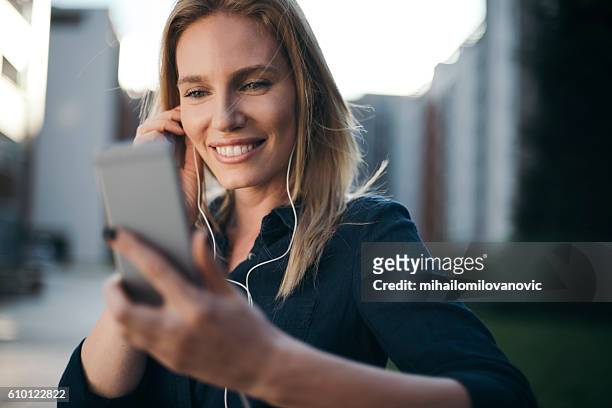 young woman listening to music - lady relaxing in sun radio stock pictures, royalty-free photos & images