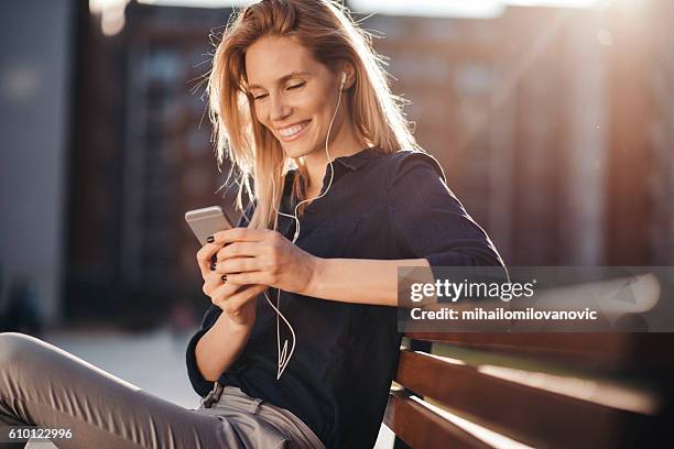 attractive girl with headphones embracing the sunny day - listening to radio stock pictures, royalty-free photos & images