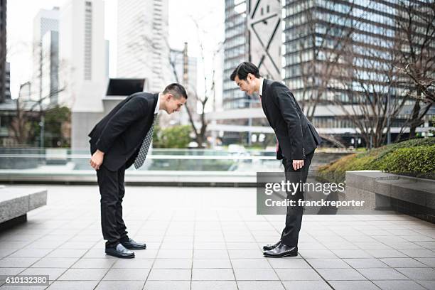 japanese business greetings together on the downtown - japanese respect stock pictures, royalty-free photos & images