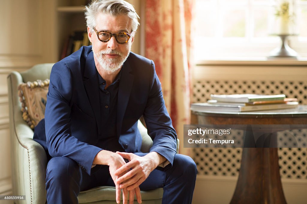 High class mature man portrait at home.