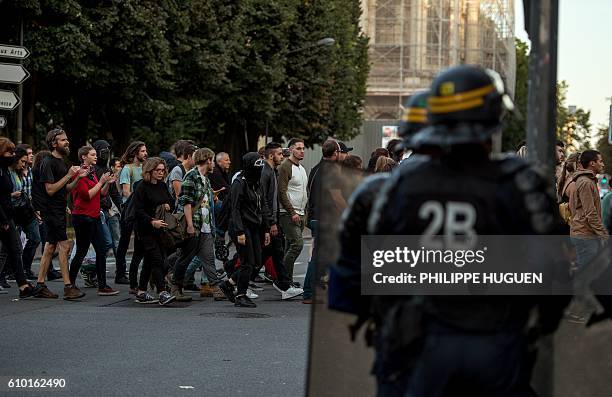 Riot policemen onwatch as some 500 people, mainly from far-left groups, protest on September 24, 2016 in Lille against the opening of a private bar...