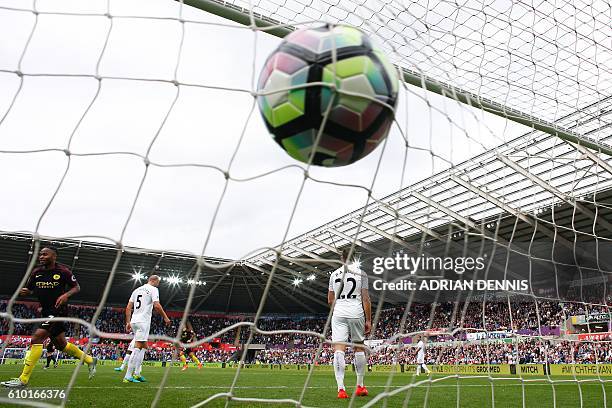 The ball slams into the back of the net after Manchester City's Argentinian striker Sergio Aguero scored his first goal during the English Premier...