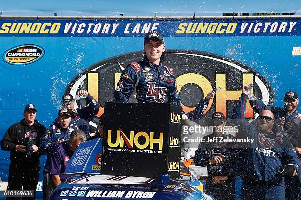 William Byron, driver of the Liberty University Toyota, celebrates in Victory Lane after winning the NASCAR Camping World Truck Series UNOH 175 at...
