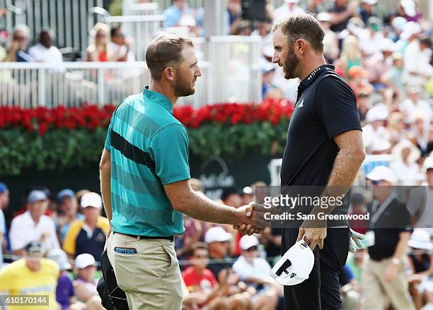 Kevin Chappell and Dustin Johnson shake hands on the 18th green during the third round of the TOUR Championship at East Lake Golf Club on September...