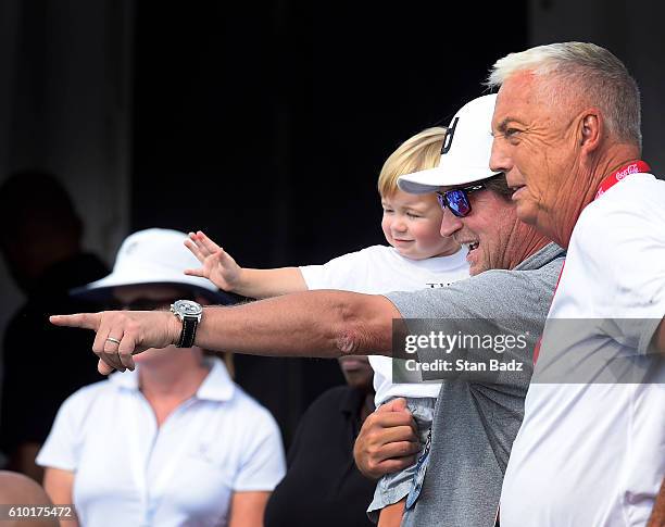 Wayne Gretzky and his grandson Tatum Johnson watch Dustin Johnson approach the 18th green during the third round of the TOUR Championship, the final...