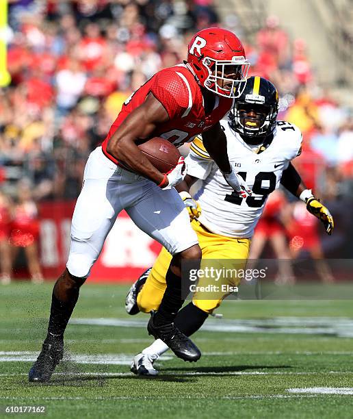 Andre Patton of the Rutgers Scarlet Knights carries the ball as Miles Taylor of the Iowa Hawkeyes defends at High Point Solutions Stadium on...