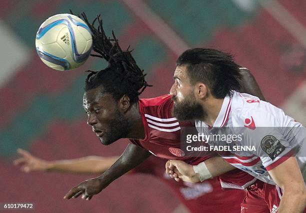 Zamalek Sporting Club's Hazem Mohammed Abdehamid Emam vies for the ball against Wydad Athletic Club's Serigne mourtada Fall during the CAF Champions...