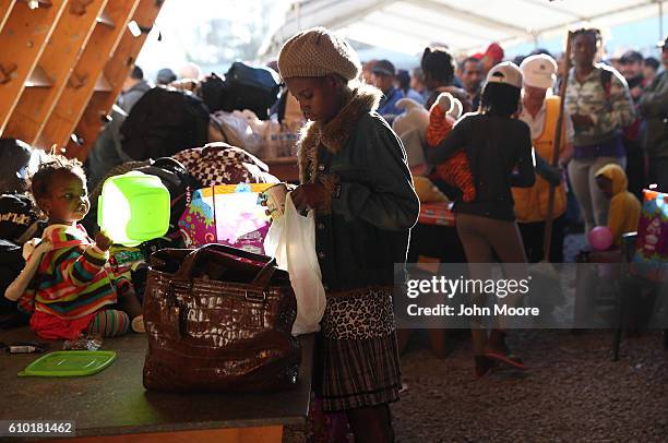 Haitian refugees look over donated items at an immigrant center on September 24, 2016 in Tijuana, Mexico. In recent months a surge of Haitian...