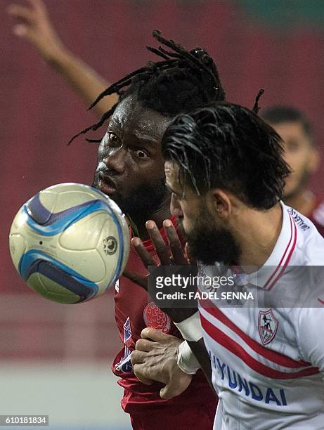 Zamalek Sporting Club's Hazem Mohammed Abdehamid Emam vies with the Wydad Athletic Club's Serigne mourtada Fall during the CAF Champions League...