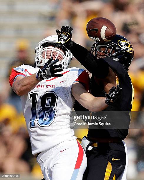 Defensive back John Gibson of the Missouri Tigers breaks up a pass indended for wide receiver Mason Rutherford of the Delaware State Hornets during...