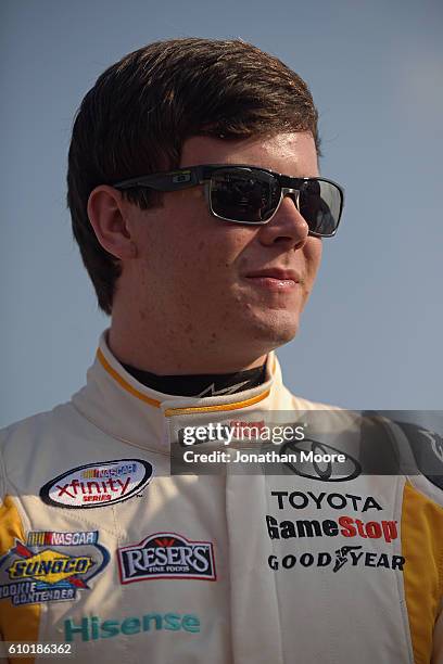 Erik Jones, driver of the GameStop Toyota, stands next to his car before qualifying for the NACAR XFINITY Series VisitMyrtleBeach.com 300 at Kentucky...