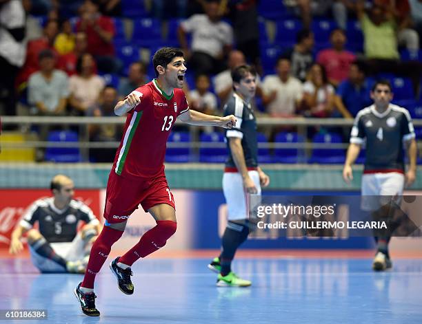 Iran's player Farhad Tavakoli celebrates a goal scored by his teammate Ahmad Esmaeilpour against Paraguay during their Colombia 2016 FIFA Futsal...