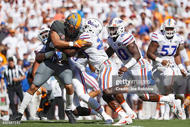 Group of Florida Gators defenders make a tackle behind the line of scrimmage against Jalen Hurd of the Tennessee Volunteers in the first quarter at...