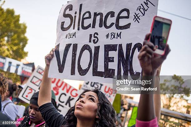 Demonstrators march through the streets following a rally at Marshall Park September 24, 2016 in uptown Charlotte, North Carolina. Protests have...