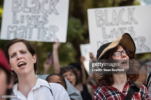 Demonstrators cheer for a speaker during a rally at Marshall Park September 24, 2016 in uptown Charlotte, North Carolina. Protests have disrupted the...