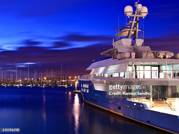 super luxury yatch moored on auckland harbour with marina in background - super yacht stock pictures, royalty-free photos & images