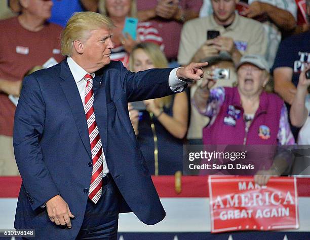Republican presidential nominee Donald Trump acknowledges supporters during a campaign event at the Berglund Center on September 24, 2016 in Roanoke,...