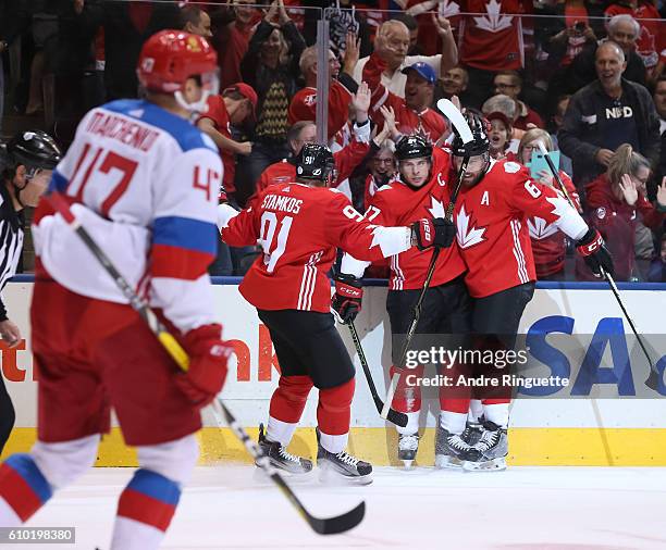 Sidney Crosby celebrates with Steven Stamkos and Shea Weber of Team Canada after scoring a first period goal on Team Russiaat the semifinal game...