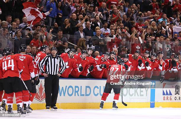 Sidney Crosby of Team Canada high fives the bench after scoring a first period goal on Team Russia at the semifinal game during the World Cup of...