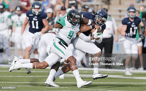 Wide receiver Parker Smith of the Rice Owls is chased by defensive back Nate Brooks of the North Texas Mean Green in the first half at Rice Stadium...