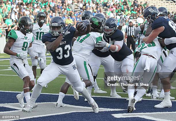 Running back Emmanuel Esukpa of the Rice Owls rushes for a touchdown against the North Texas Mean Green defense in the first half at Rice Stadium on...
