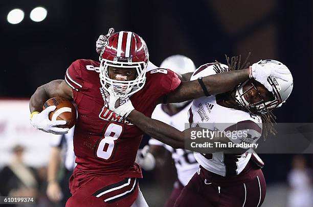 Marquis Young of the Massachusetts Minutemen stiff arms Lashard Durr of the Mississippi State Bulldogs during the second half of their game at...