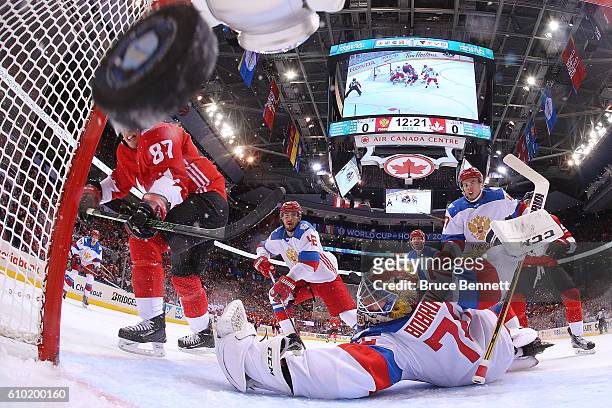 Sidney Crosby of Team Canada scores a first period goal past a diving Sergei Bobrovsky of Team Russia at the semifinal game during the World Cup of...