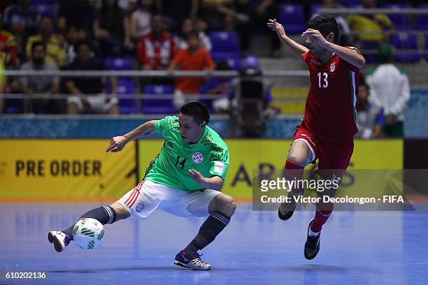 Rene Villalba of Paraguay keeps the ball in play as Farhad Tavakoli of Iran keeps pace during quarterfinal match play between Paraguay and Iran in...