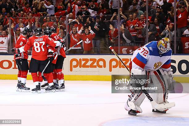 Sergei Bobrovsky of Team Russia reacts as Brad Marchand of Team Canada is congratulated by his teammates after scoring a second period goal at the...