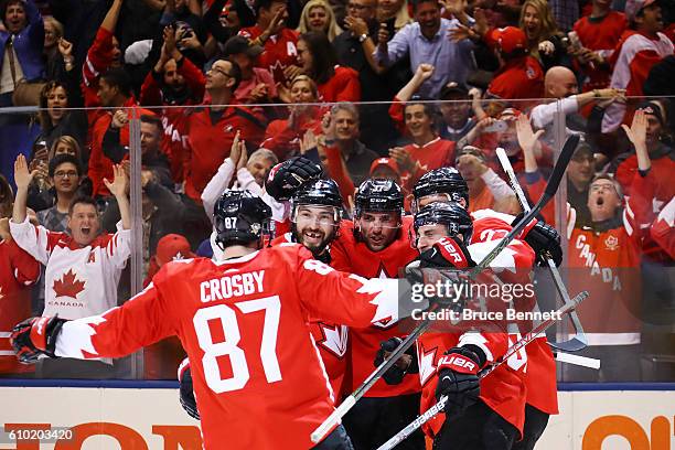 Brad Marchand of Team Canada is congratulated by his teammates Sidney Crosby, Drew Doughty, Patrice Bergeron and Alex Pietrangelo after scoring a...