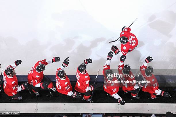 Sidney Crosby of Team Canada celebrates his first period goal against Team Russia with teammates at the players bench during the World Cup of Hockey...