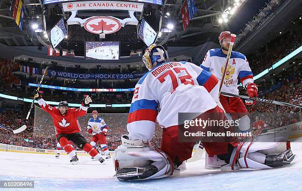 Patrice Bergeron of Team Canada celebrates a third period goal by Brad Marchand against Sergei Bobrovsky of Team Russia at the semifinal game during...