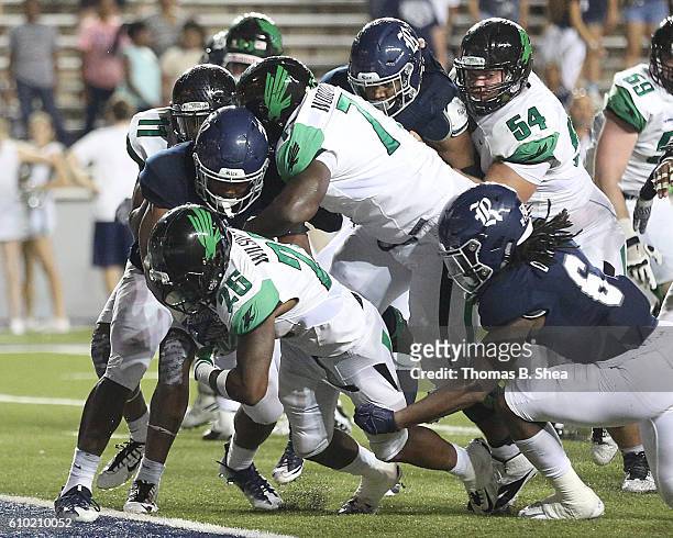 Running back Jeffrey Wilson of the North Texas Mean Green rushes for a touchdown in overtime against the Rice Owls at Rice Stadium on September 24,...