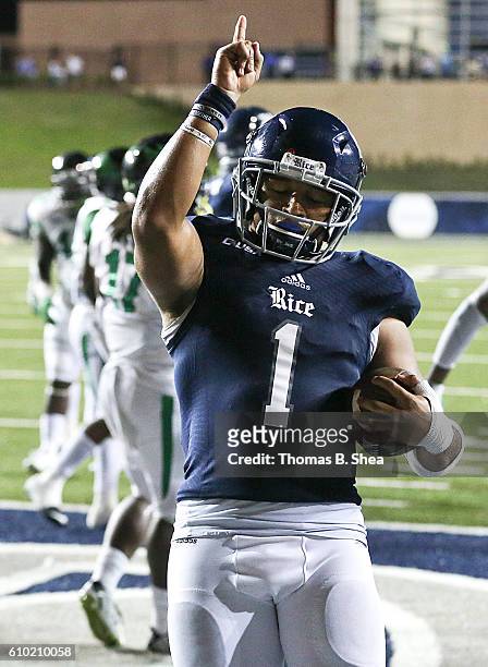 Running back Darik Dillard of the Rice Owls reacts after rushing for a touchdown against the North Texas Mean Green in overtime at Rice Stadium on...