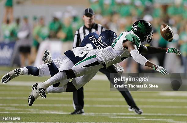 Defensive back Kishawn McClain of the North Texas Mean Green breaks up a pass intended for wide receiver Darrion Pollard of the Rice Owls in the...