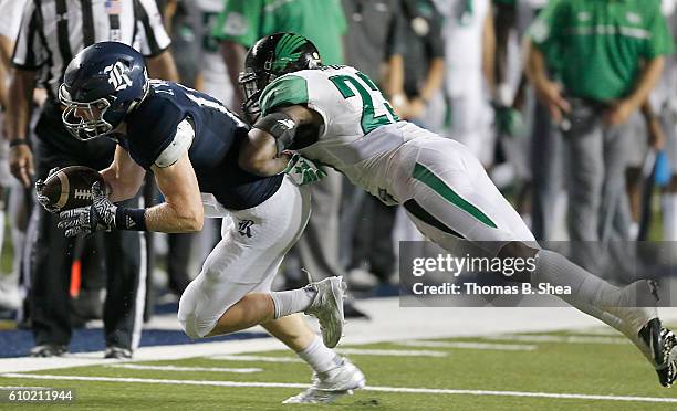 Wide receiver Zach Wright of the Rice Owls is tackled by defensive back Kishawn McClain of the North Texas Mean Green in the second half at Rice...