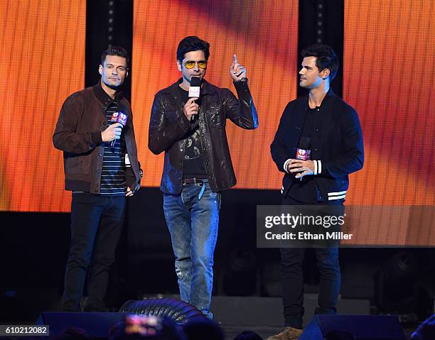 Host Ryan Seacrest and actors John Stamos and Taylor Lautner introduce a performance by Britney Spears at the 2016 iHeartRadio Music Festival at...