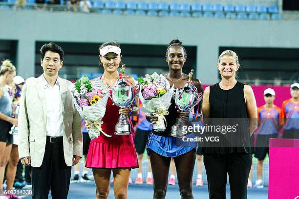 Peng Shuai of China and Asia Muhammad of the US pose with trophies after winning Vera Lapko and Olga Govortsova of Belarus in the doubles final match...