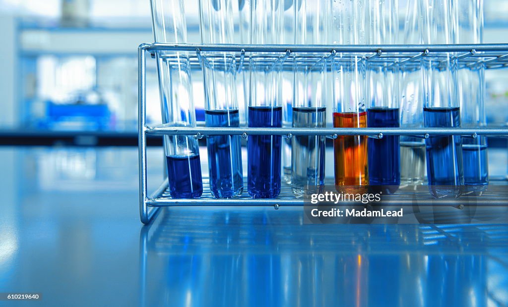 Orange and blue chemical solution in test tubes in science lab