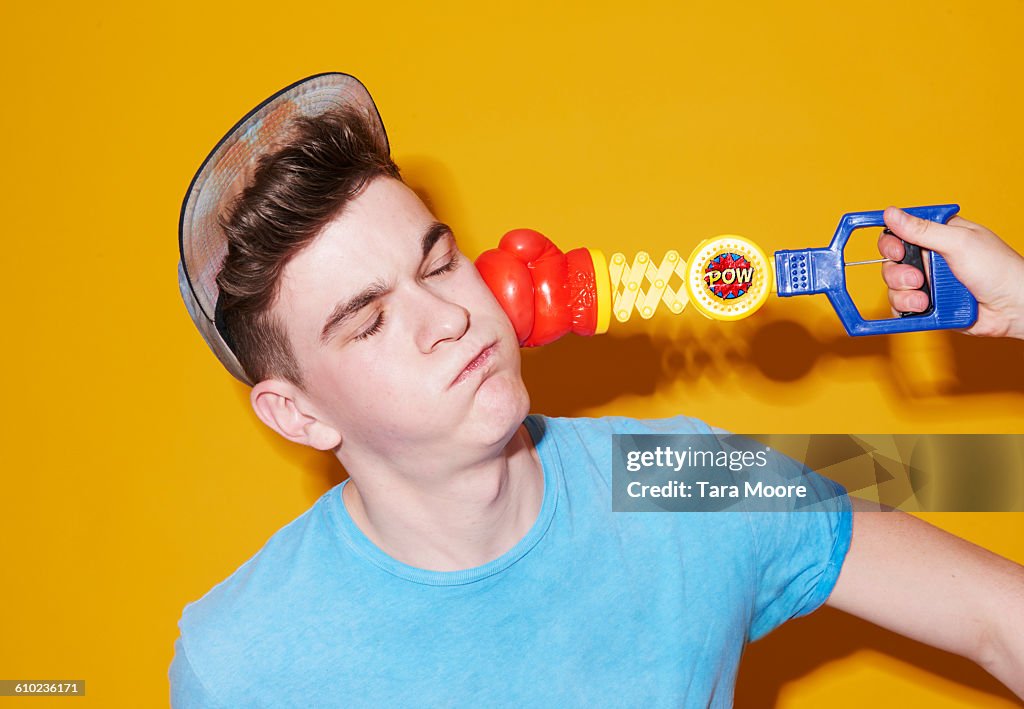 Man being pinched by toy boxing glove