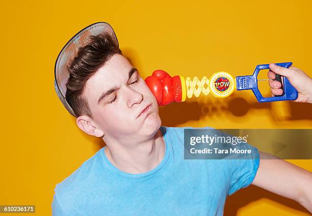 man being pinched by toy boxing glove - nocaute - fotografias e filmes do acervo