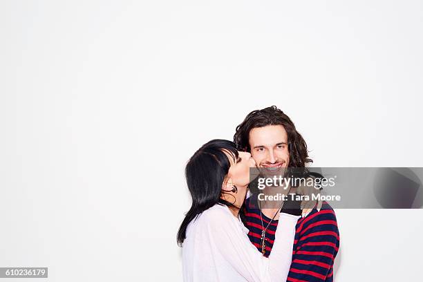 woman kissing man - studio kiss stock pictures, royalty-free photos & images