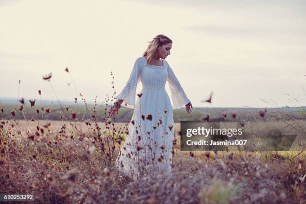 beautiful woman in a meadow - vit klänning bildbanksfoton och bilder