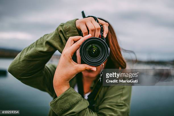 young woman using dslr camera - journalism stock pictures, royalty-free photos & images