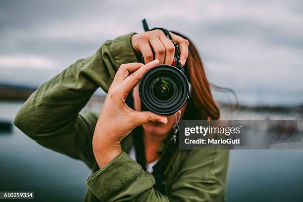 young woman using dslr camera - photographing stock pictures, royalty-free photos & images