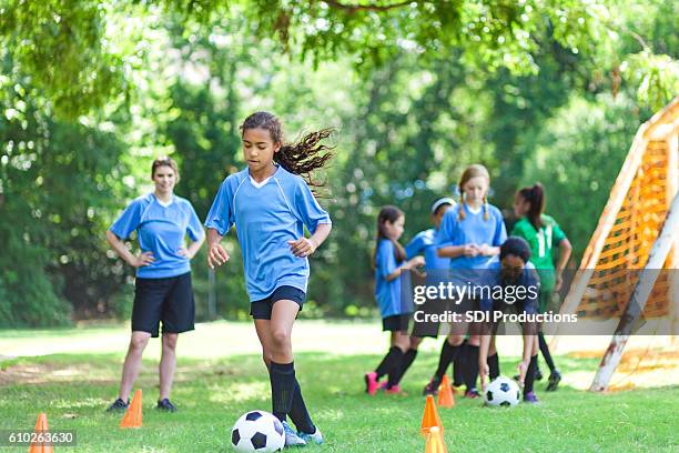 talented soccer player kicks ball around practice cones - practice drill stock pictures, royalty-free photos & images