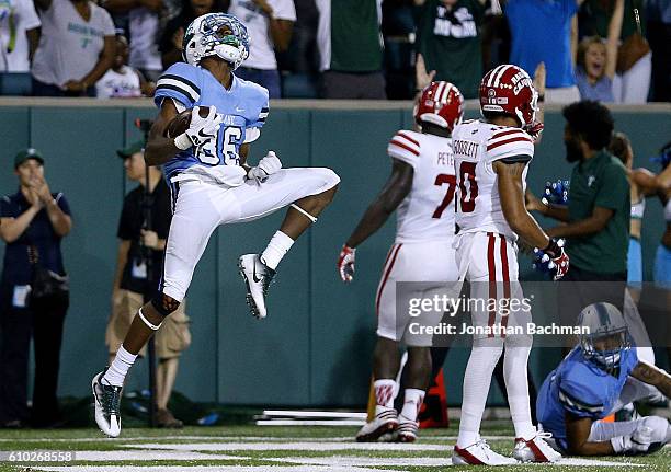 Darnell Mooney of the Tulane Green Wave celebrates a touchdown during double overtime of a game against the Louisiana-Lafayette Ragin Cajuns at...