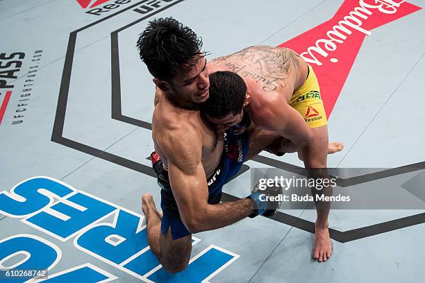 Renan Barao of Brazil controls the body of Phillipe Nover of the United States in their flyyweight bout during the UFC Fight Night event at Nilson...