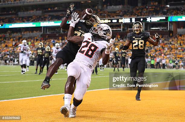 Verkedric Vaughns of the Baylor Bears breaks up a pass intended for James Washington of the Oklahoma State Cowboys in the end zone at McLane Stadium...