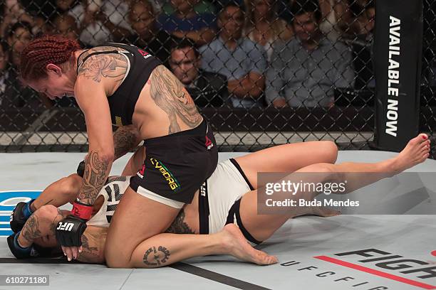 Cris Cyborg of Brazil punches Lina Lansberg of Sweden in their catchweight bout during the UFC Fight Night event at Nilson Nelson gymnasium on...